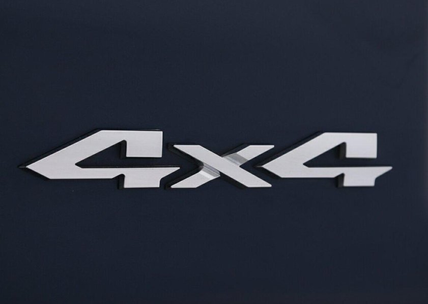 4x4 badge on the tailgate of an American pickup
